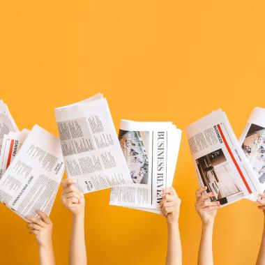 des journaux tenus pas des mains tendues